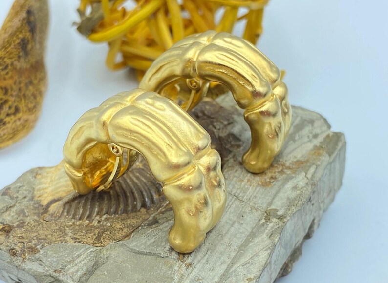 80s Givenchy bamboo clip on earrings in a matte gold tone finish