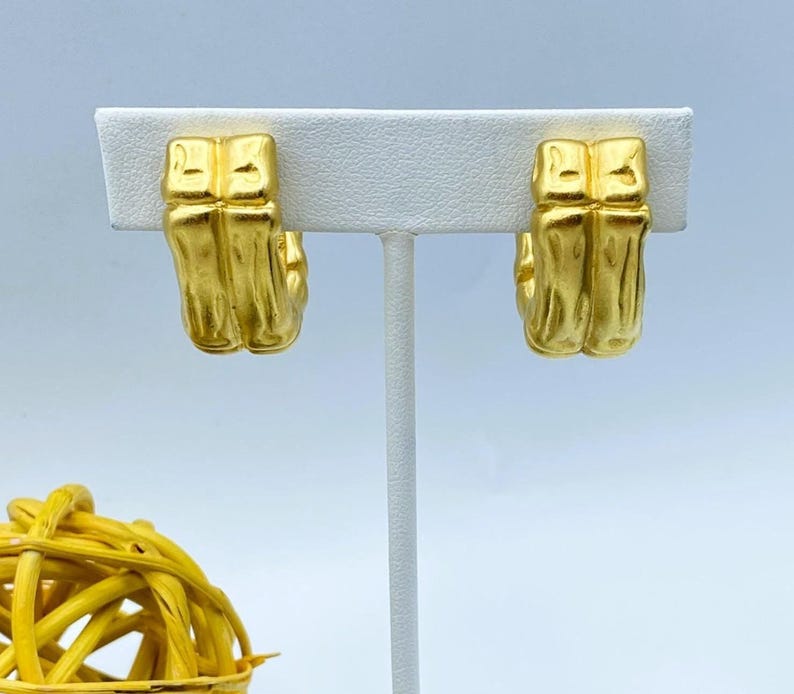 80s Givenchy half hoop bamboo clip on earrings in matte gold tone finish