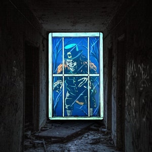 May include: A creepy, green-faced leprechaun with a hat is trapped behind a window in an abandoned building. The window is framed in white and has a blue background.