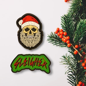 May include: Two embroidered patches, one with a skull wearing a Santa hat and the other with the word "SLEIGHER" in green and red.