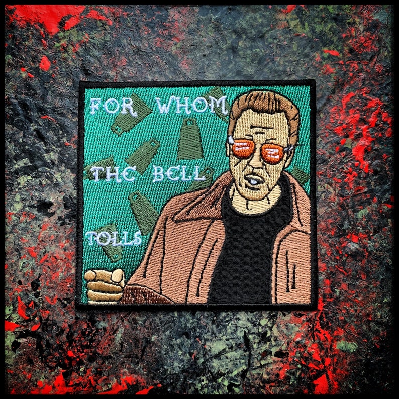 May include: Embroidered patch featuring a man with sunglasses and a brown jacket, with the text "FOR WHOM THE BELL TOLLS" in green.