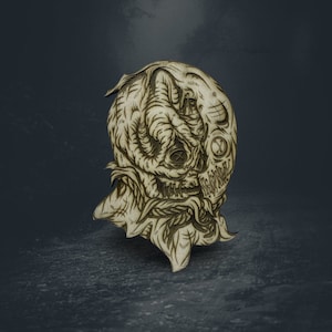 May include: A wooden, laser-cut, stylized illustration of a creature's head. The design features intricate details, including a skull-like face, tentacles, and floral elements. The artwork is in shades of brown and beige, with a dark background.