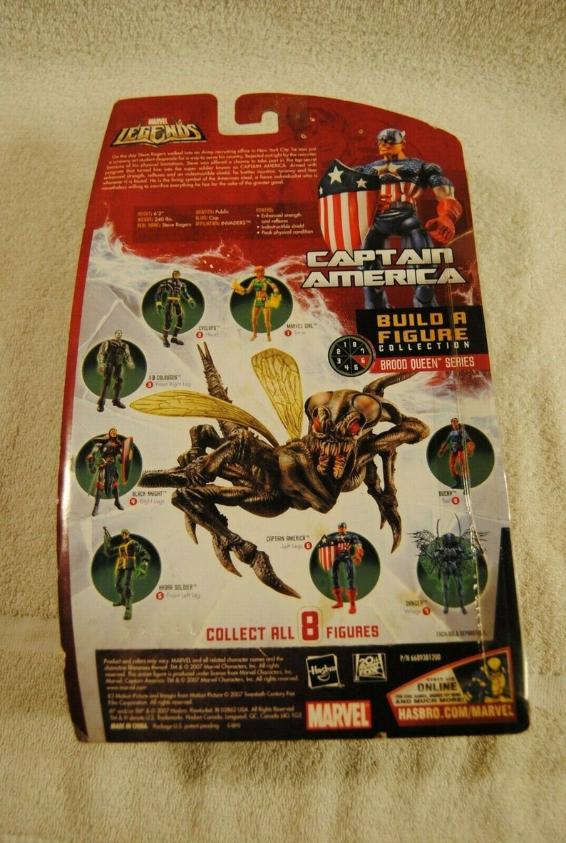 May include: Marvel Legends action figure packaging featuring Captain America and a Brood Queen. The packaging includes images of other figures in the series, with the text "Build a Figure Collection" and "Collect All 8 Figures."