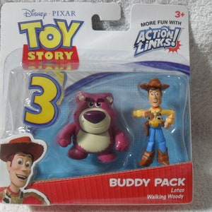 May include: A Toy Story 3 Action Links Buddy Pack featuring a purple Lotso bear figure and a Walking Woody figure in original blister packaging. The packaging includes the Toy Story 3 logo, the Action Links logo, and text identifying the characters.