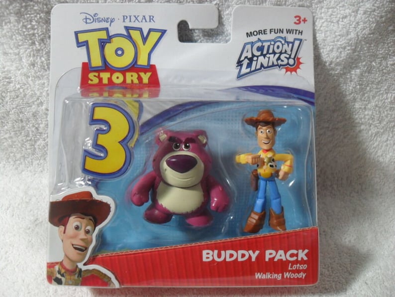 May include: A Toy Story 3 Action Links Buddy Pack featuring a purple Lotso bear figure and a Walking Woody figure in original blister packaging. The packaging includes the Toy Story 3 logo, the Action Links logo, and text identifying the characters.