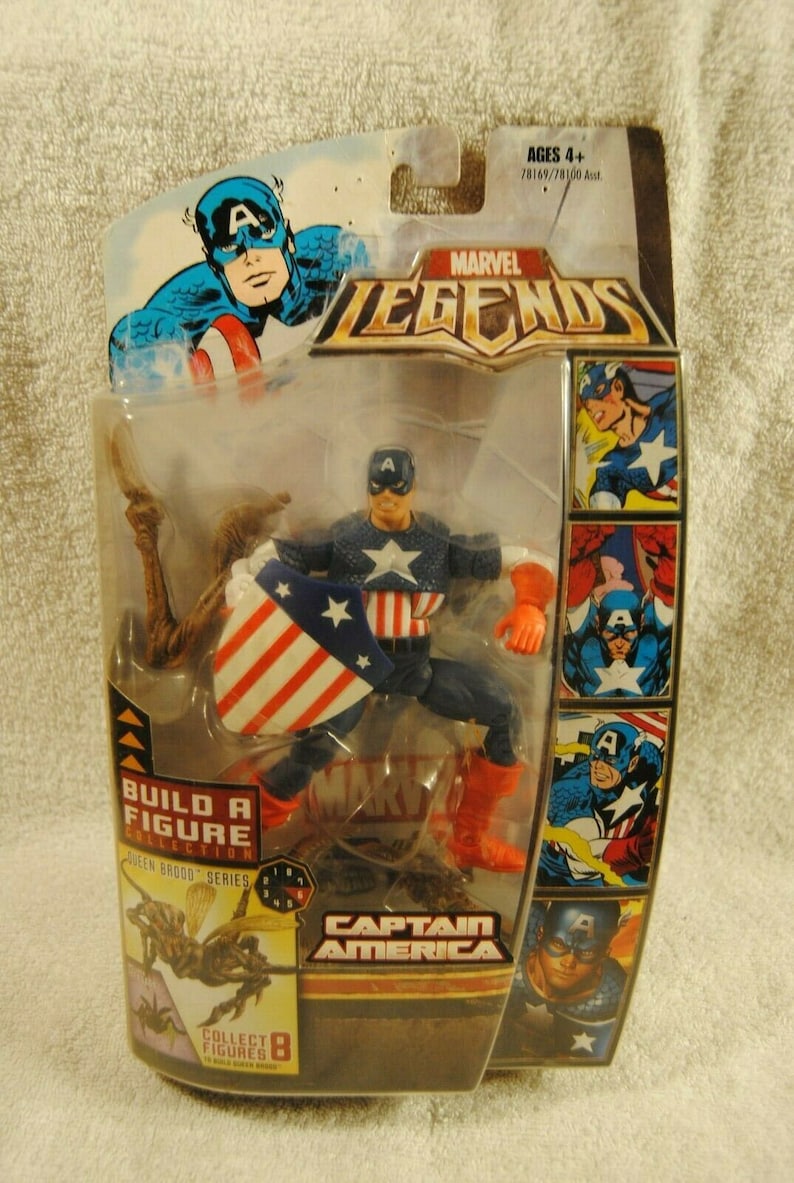 May include: Marvel Legends Captain America action figure in original packaging. The figure is in a dynamic pose, holding a shield with red and white stripes and a blue star field. The packaging includes comic book art and the text "Captain America."