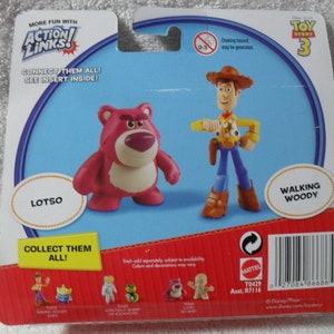 May include: A Toy Story 3 Action Links blister card featuring a pink Lotso bear figure and a Walking Woody figure. The packaging includes the text More Fun With Action Links, Connect Them All, See Insert Inside, Lotso, Walking Woody, and Collect Them All.
