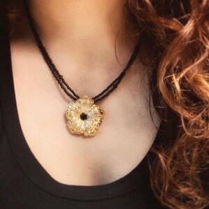 Beaded necklace with Gold flower pendant