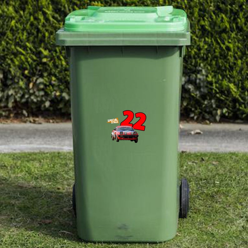 May include: Green recycling bin with a sticker of a red race car with the number 22 and the words "Special Stage" on it.