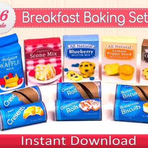 May include: A miniature breakfast baking set featuring boxes and rolls of breakfast foods. The set includes boxes of waffle mix, scone mix, blueberry muffin mix, lemon poppy seed muffin mix, and chocolate chip muffin mix. Also included are crescent rolls, cinnamon rolls, and buttermilk biscuits. The text "Breakfast Baking Set" is visible.