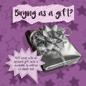 May include: A wrapped gift with a silver bow on a purple background. The text "Buying as a gift?" is above the gift. A speech bubble states "Gift wrap with an optional gift note is available to add on at check out."