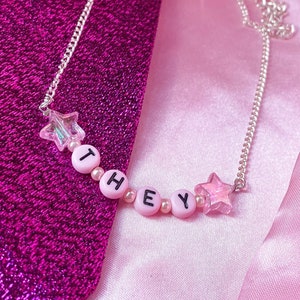 THEY necklace, cute light pink letter bead necklace with iridescent star charms, non binary pronoun statement necklace