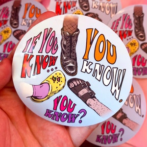 May include: A round sticker with the text "IF YOU KNOW YOU KNOW" in a retro font. The sticker features illustrations of different types of footwear, including boots, sandals, and clogs. The background is a light blue color.
