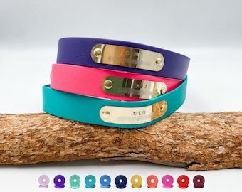 May include: Three stacked bracelets in purple, pink, and teal, each featuring a gold-toned metal nameplate secured with rivets. The nameplates are engraved with the names Olivia, Mia, and Ned. A row of small colored circular icons is below.