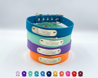 May include: A stack of four waterproof pet collars in blue, mint green, purple, and orange. Each collar features a silver-tone metal buckle and a rectangular identification plate engraved with the names ATLAS or ODIN and phone numbers.