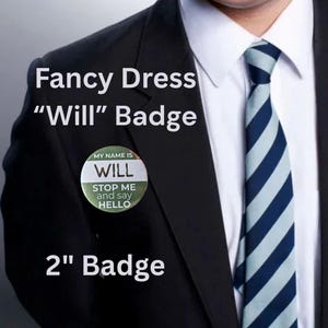 May include: A 5 cm round badge for fancy dress, featuring the name "Will". The badge includes the text "Stop me and say hello." It is pinned to a black suit jacket. The text "2" Badge" is also visible.