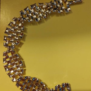 Vintage gold tone bracelet. Made by Coro this bracelet is linked together with an alligator clasp. This bracelet was made about the 1940s.