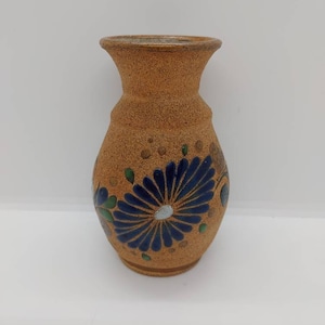 Mexican pottery vase. Vintage. A blue flower and more flower designs are around this vase. Vase is in perfect condition,no chips or cracks.