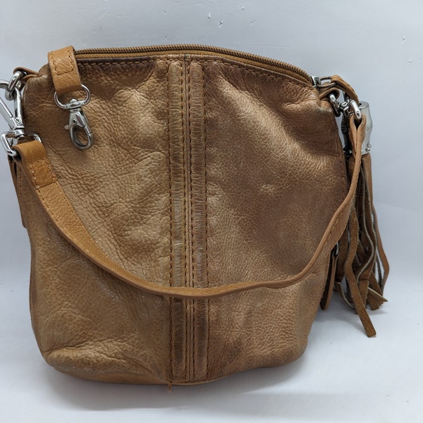 Leather purse Italian Danier. This leather purse is imperfect condition. There is a zipper on the top. 2 zipper pouchs on each side.A tassel