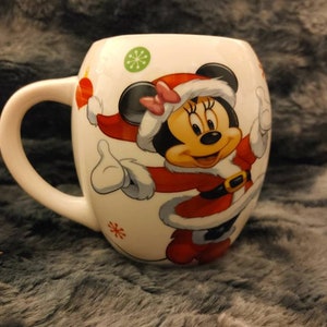 Mickey and Minnie Christmas mug. This is a cute Christmas mug of Mickey and Mini in their Christmas finest. Perfect for hot chocolate.