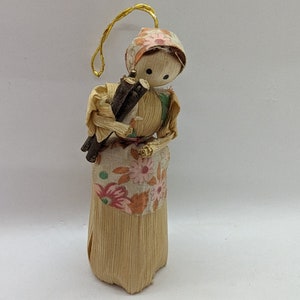 Corn husk doll. This is a vintage corn husk doll. This doll is in perfect condition. She is caring a bundle of sticks.