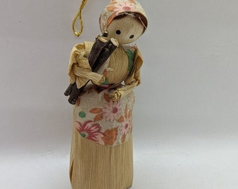 Corn husk doll. This is a vintage corn husk doll. This doll is in perfect condition. She is caring a bundle of sticks.