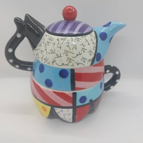 Buy Whimsical cat teapot cup and saucer by Romero Britto. This very colorful and playful cat tea set has no chips or cracks.