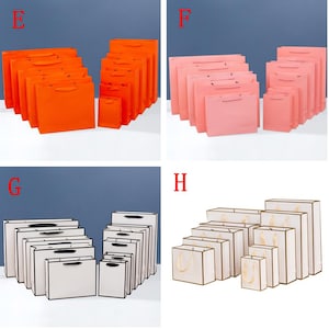 May include: Set of 10 orange, pink, and white paper gift bags with black handles. The bags are arranged in size order from smallest to largest.