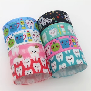 May include: A stack of colorful ribbon with a tooth and dental themed print. The ribbon is 2.5 inches wide and is perfect for crafting, hair bows, and other projects.