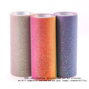 Könnte beinhalten: Drei Rollen Glitzer-Tüllstoff in Rosa-, Orange- und Lilatönen. Die Rollen sind zylindrisch und haben eine glitzernde Textur. Das Bild enthält den Text: "100% real shooting. Unauthorized use our pictures, we will complaint you and pursue your leagal responsibility."