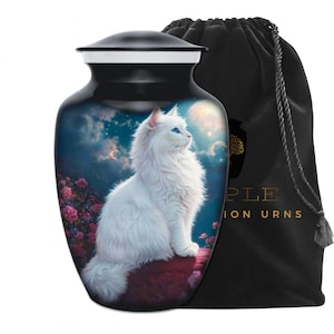 May include: A black and white pet urn with a white cat illustration. The cat has blue eyes and is set against a night sky background with a full moon and pink flowers. A black velvet bag is included.