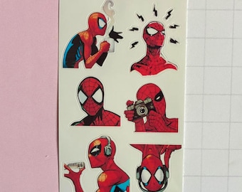 May include: A sticker sheet featuring six distinct illustrations of the red and blue Spider-Man character. The graphics show the character drinking from a mug, reacting with surprise, posing, holding a camera, holding a microphone, and wearing headphones.