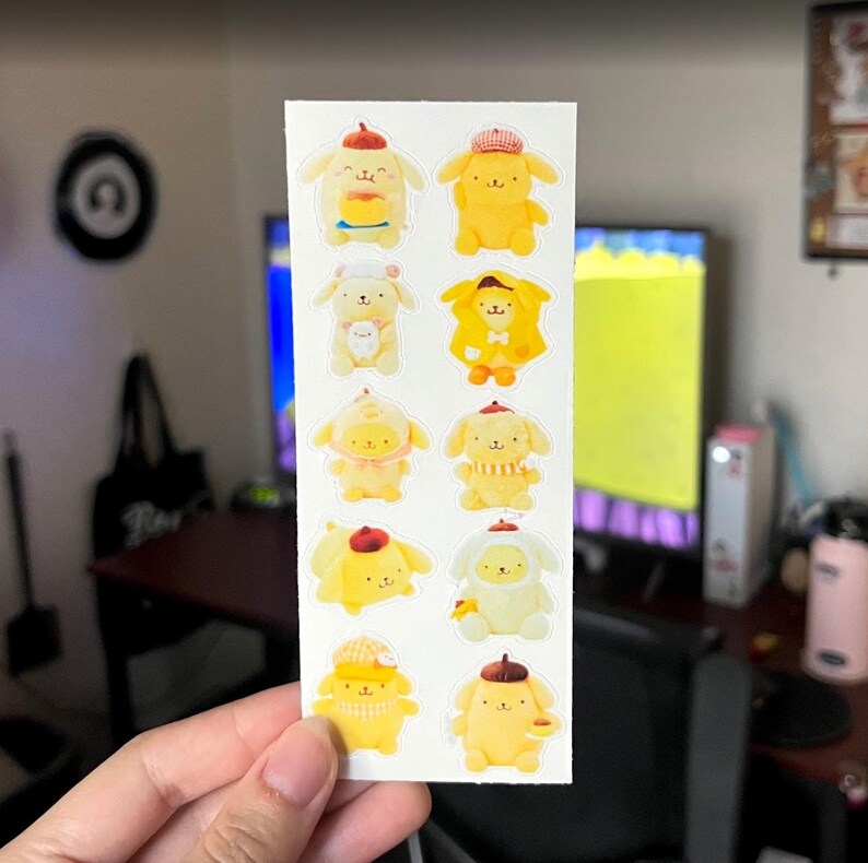 May include: A sheet of stickers featuring cartoon characters in various poses and outfits. The characters are primarily yellow with white accents, wearing hats, scarves, and holding items. The stickers are on a white background.