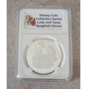 Disney Medallion Coin Collective Series Lady and Tramp having romantic spaghetti dinner LE150 displayed and protected in beautiful coin slab