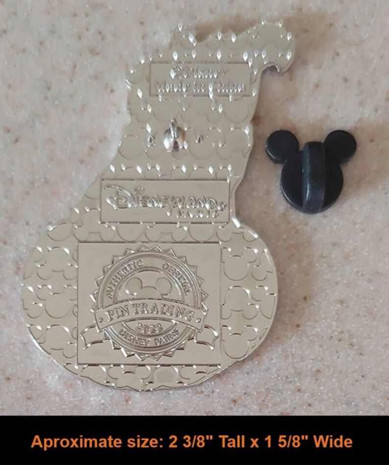 May include: Silver-toned metal pin featuring a cartoon pumpkin with a Mickey Mouse face. The back of the pin has a Mickey Mouse head pin back, a "Disneyland Resort" logo, and an "Authentic Official Pin Trading 2022 Disney Parks" label. The pin is approximately 2 3/8 inches tall and 1 5/8 inches wide.