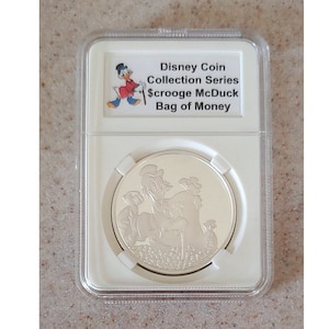 Disney Medallion Coin Collective Series Scrooge McDuck Series #4 of 5 Bag of Money LE150 displayed and protected in a beautiful coin slab