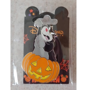 May include: A silver pin featuring a cartoon black cat sitting on top of an orange jack-o'-lantern. The pin has a black background with the text "Disneyland Paris" and a spider web design.