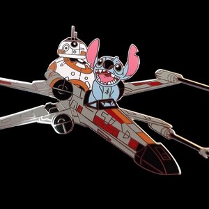 May include: A blue and white Stitch character from Disney's Lilo & Stitch is piloting an X-Wing fighter from Star Wars.  The X-Wing is gray, red, and black with a white and orange stripe.  BB-8, a white and orange droid, is sitting in the co-pilot seat.