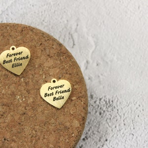 Heart-shaped bridle tag in gold or silver finish, featuring custom engraving on both sides, secured with lobster clasp and double ring hoop.
