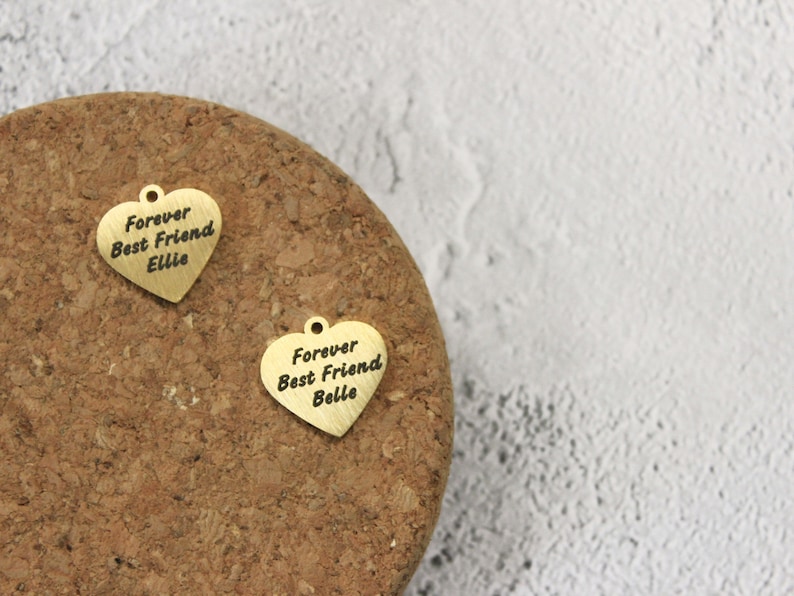 Heart-shaped bridle tag in gold or silver finish, featuring custom engraving on both sides, secured with lobster clasp and double ring hoop.