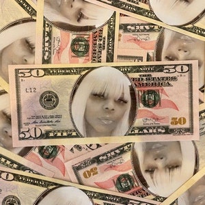 May include: A collection of fifty-dollar bills, with a portrait of a woman with white hair superimposed on each bill. The bills are in shades of pink, green, and beige, with the number 50 prominently displayed.