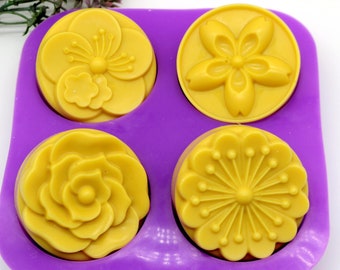 May include: Four yellow soap bars in a purple silicone mold. Each soap bar has a different floral design.