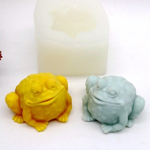 May include: Two frog-shaped silicone molds, one yellow and one light blue, for making soap or candles.