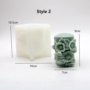 May include: Style 2 silicone mould for making candles. The mould is 10.5 cm tall and 10 cm wide. The finished candle is 9 cm tall and 7 cm wide and features a floral design.