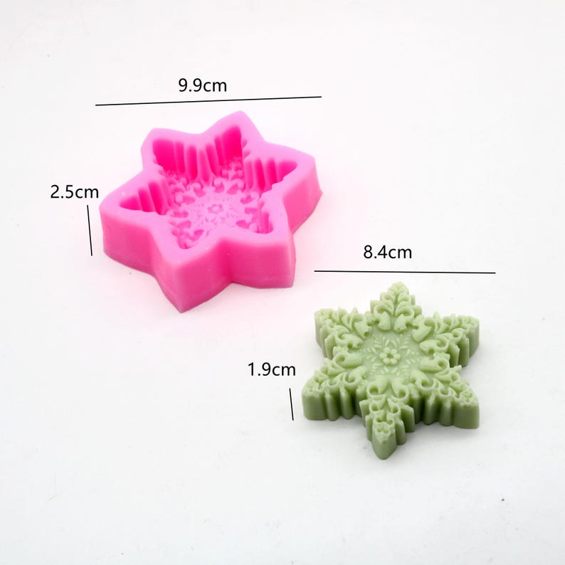 May include: Pink silicone snowflake mold measuring 9.9 cm wide and 2.5 cm tall. A green snowflake made with the mold measures 8.4 cm wide and 1.9 cm tall.