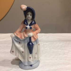 Ceramic figurine , occupied Japan marked ceramic figurine beautiful women painted in blue ,white and red colors , 50’s