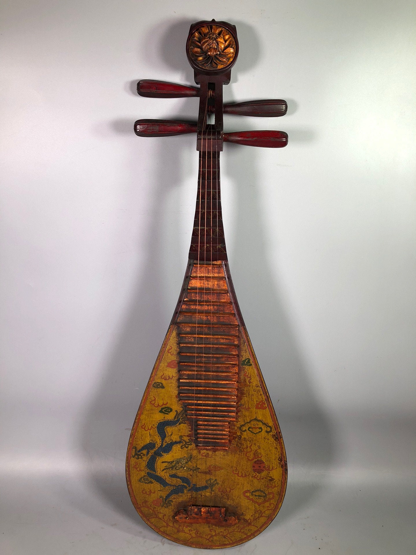 Antique Asian music instrument, pipa, hung in wall in a music