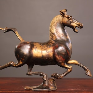 A rare and exquisite handcrafted Chinese antique bronze horse stepping on a flying swallow statue