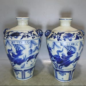 A pair of exquisite and rare Chinese antique hand-painted blue and white figure story vase ornaments