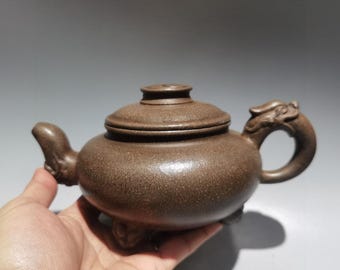 Exquisite antique Chinese Zisha teapot featuring intricate, purely handmade clay-slip painting of a dragon.